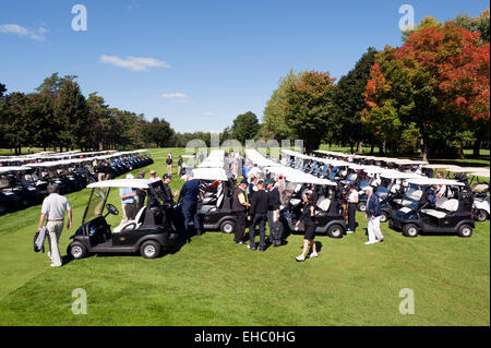 Players getting to their carts for the shotgun start at a corporate golf tournament. Stock Photo