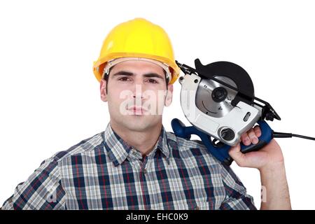 Man posing with electrical saw Stock Photo