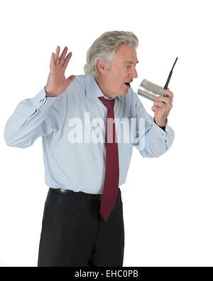 Business man talking into can with antenna Stock Photo