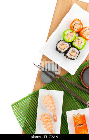 Sushi maki and shrimp sushi on bamboo board. Isolated on white background with copy space Stock Photo