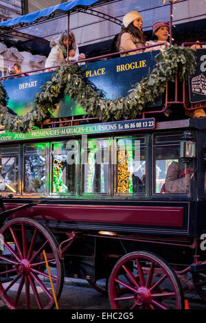 Horse-drawn double-decker bus riding tourists at Christmas time Strasbourg Alsace France Europe Stock Photo