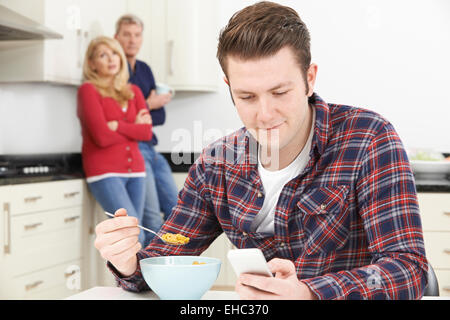Mature Parents Frustrated With Adult Son Living At Home Stock Photo