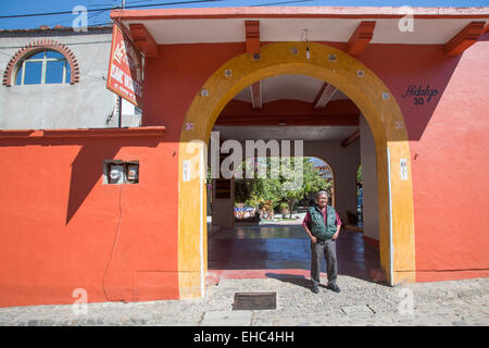 Teotitlán del Valle, Oaxaca, Mexico - Isaac Vásquez García stands in front of 'The Bug in the Rug' workshop, which weaves rugs. Stock Photo