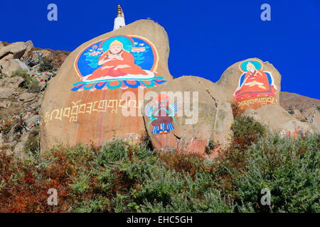 Tibetan buddhist paintings on mani stones -om mani padme hum- in the Drepung-Rice Heap monastery of the Gelugpa-Yellow Hat order Stock Photo