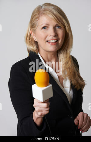 Female Journalist With Microphone On White Background Stock Photo