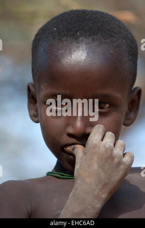 A Samburu child with right thumb on his lips, Ngurunit area, Kenya Stock Photo