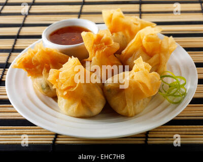 Traditional chinese dim sum with a chilli dipping sauce, serving suggestion on a plate Stock Photo