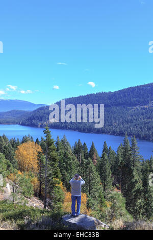 Man takes photo of scenic Tahoe National Forest views on the California side of the Sierra Nevada. Stock Photo