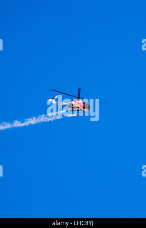 The Red Bull Stunt Helicopter performing Aerobatics at the 2011 Wings Over Camarillo Air Show in Camarillo California Stock Photo