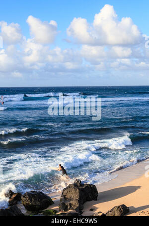 Surfer and windsurfer at Hookipa Beach on Maui Stock Photo