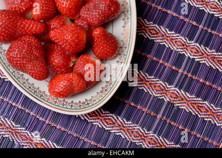 Fresh strawberries placed in a white ceramic dish with model Stock Photo