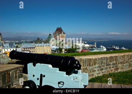 Old cannon on stone battlements view of Hotel Chateau Frontenac St. Lawrence River from La Citadelle fortress Quebec City Stock Photo