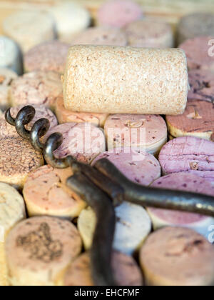 blank wine cork on the top of corks background with vintage corkscrew Stock Photo