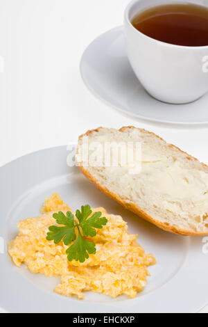 scrambled eggs and bun on a plate isolated on white Stock Photo - Alamy