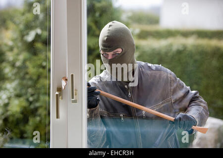 Burglar at a window Stock Photo