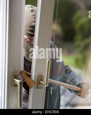 Burglar at a window Stock Photo