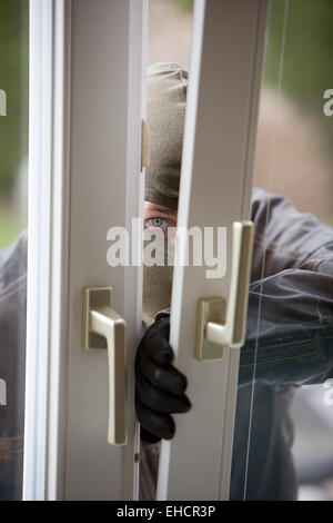 Burglar at a window Stock Photo