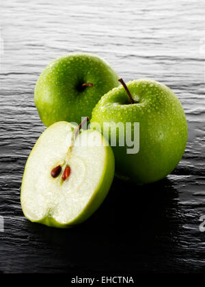 Whole & cut Granny Smith apples Stock Photo