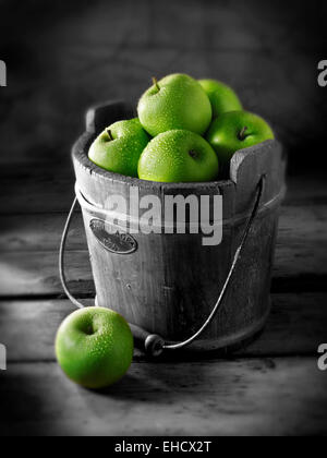 Fresh Granny Smiths apples in a wooden bucket Stock Photo