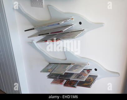 CD holder in the form of a dolphin in a home in the UK. Stock Photo