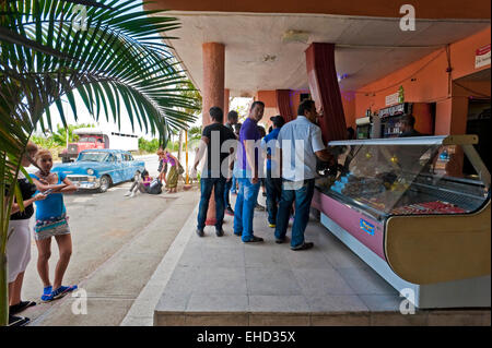 Horizontal view of people at a service station in Cuba. Stock Photo