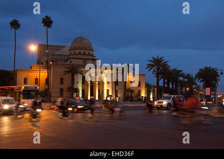 Horizontal streetscape of the Theare Royal in Marrakech at dusk with motion blur of passing traffic. Stock Photo