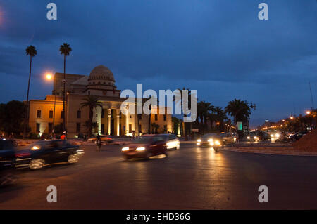 Horizontal streetscape of the Theatre Royal in Marrakech at dusk with motion blur of passing traffic. Stock Photo