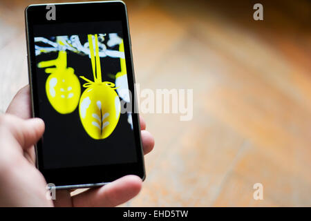 Easter greetings on smart phone made from home Stock Photo