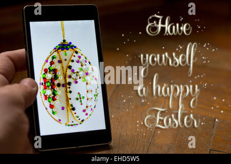 Easter greetings on smart phone with text effect Stock Photo