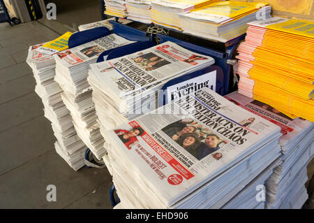 Copies of the Evening Standard outside a London commuter station. Stock Photo