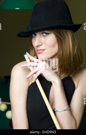 Woman with cue Stock Photo