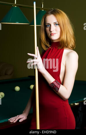 Woman in red with cue Stock Photo