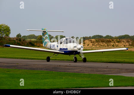 Piper PA-38-112 Tomahawk G-BMVL taxiing  from runway at Breighton Airfield Stock Photo