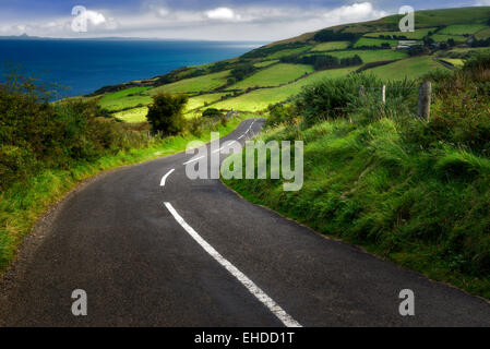 Road near Torr Head with green fields in background. Antrim Coast Northern Ireland Stock Photo