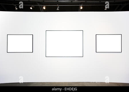 Three  empty frames on white wall Stock Photo