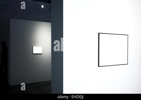 Empty frames on white wall in museum Stock Photo