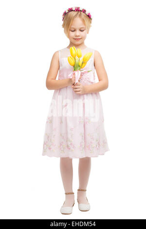 Beautiful little girl with bouquet of yellow tulips Stock Photo