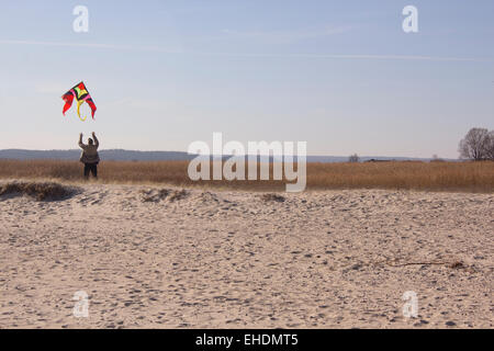 Old man playing with kite Stock Photo