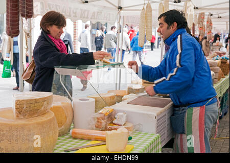 A customer makes a purchase or dairy products at the Canterbury Italian market Stock Photo