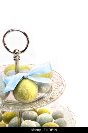Colored easter eggs on cake platter Stock Photo