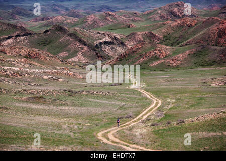 Old rural road in desert mountain Stock Photo