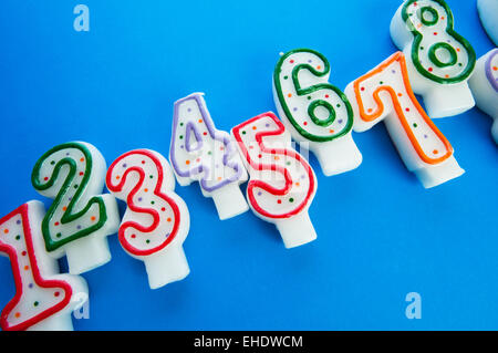 Birthday candles against colourful background Stock Photo