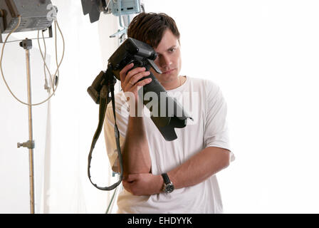 Portrait of tired photographer in studio Stock Photo