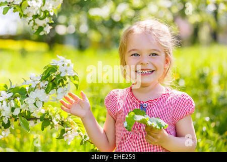 Happy little girl in spring sunny park Stock Photo