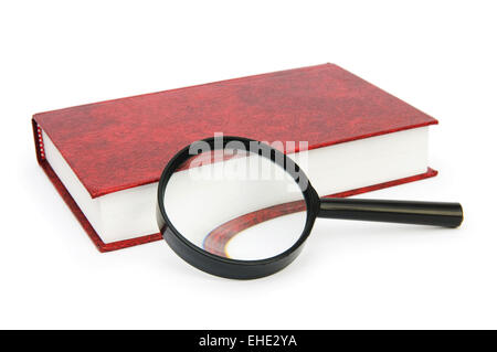 Magnifying glass over the stack of books Stock Photo