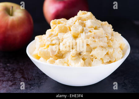 Apples with vanilla custard in a bowl. Apple pie filling. Baking ingredients, selective focus Stock Photo