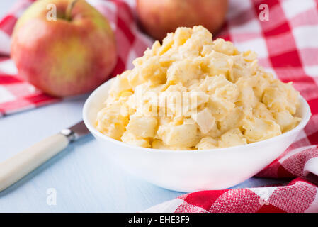 Apples with vanilla custard in a bowl. Apple pie filling. Baking ingredients, selective focus Stock Photo