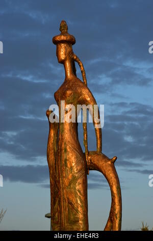 Bronze statue in abstract style featuring a Kazakh woman, in evening sunlight. in Astana, Kazakhstan Stock Photo