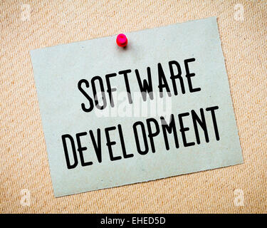 Recycled paper note pinned on cork board. Software Development Message. Concept Image Stock Photo
