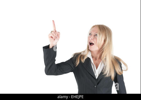 Middle aged Business woman pointing upwards Stock Photo